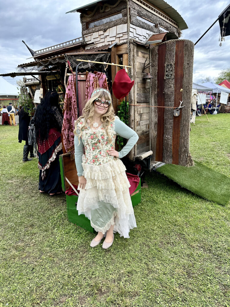 Nikki, wearing a light outfit at a Ren Faire.