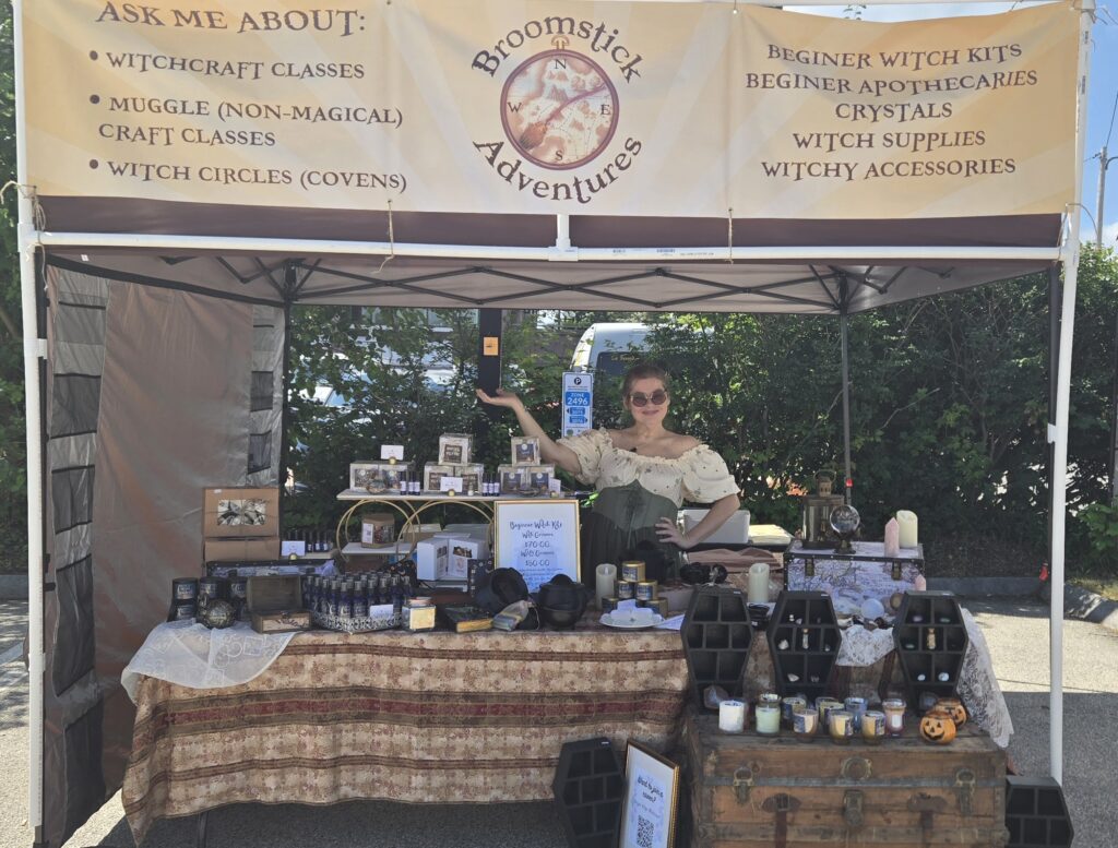 A picture of our booth at the Farmers' market, with Nikki making a display